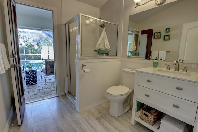 full bathroom with toilet, a stall shower, and vanity