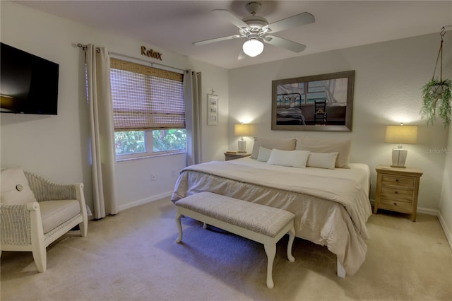 bedroom featuring a ceiling fan, baseboards, and light carpet