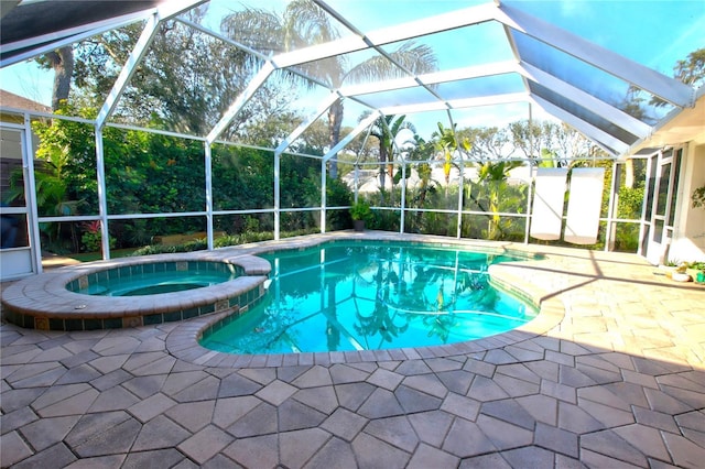 view of swimming pool with glass enclosure, a patio area, and a pool with connected hot tub