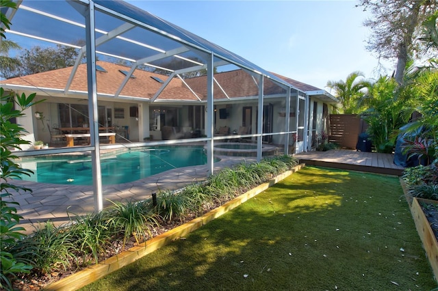 pool featuring a deck, a lanai, a yard, and a patio