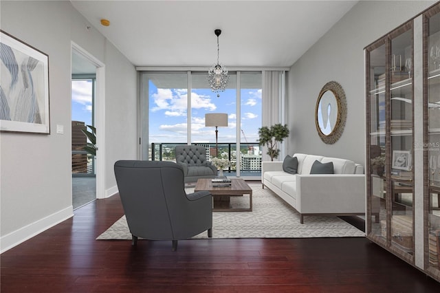 living room with a notable chandelier, wood-type flooring, and expansive windows