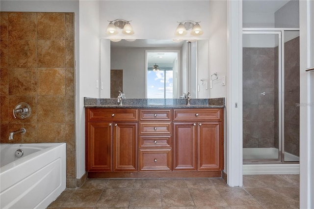 bathroom with vanity and shower with separate bathtub