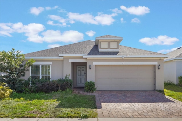 view of front of property with a garage and a front yard