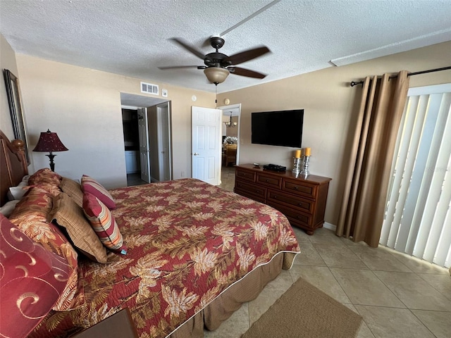 bedroom featuring ceiling fan, a textured ceiling, and light tile patterned floors