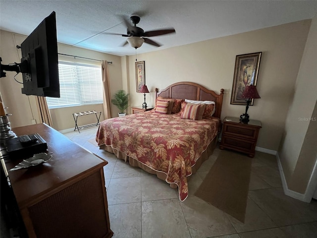 tiled bedroom featuring ceiling fan