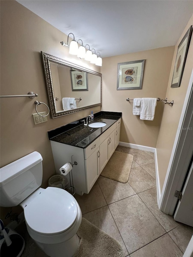 bathroom featuring vanity, tile patterned flooring, and toilet