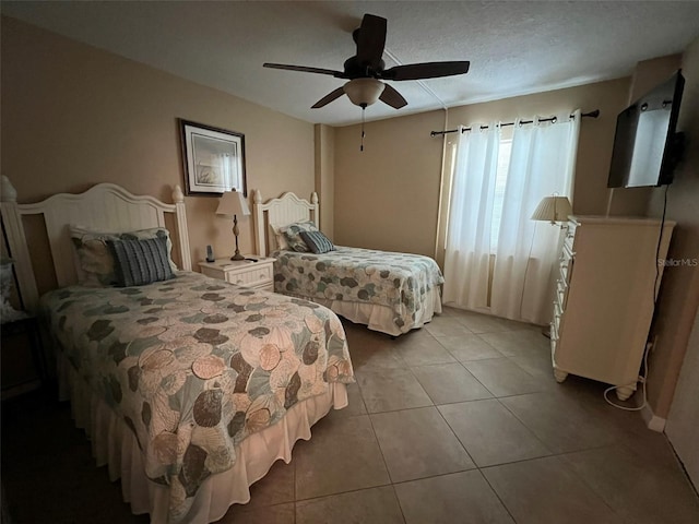 tiled bedroom featuring a textured ceiling and ceiling fan