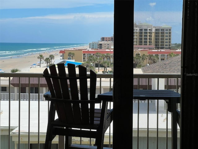 balcony with a water view and a beach view