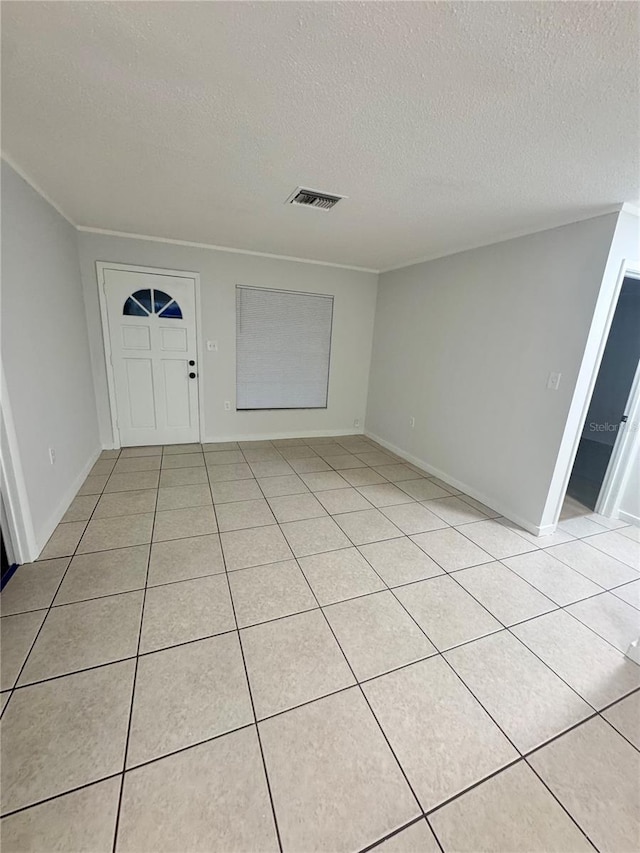 tiled entrance foyer with a textured ceiling