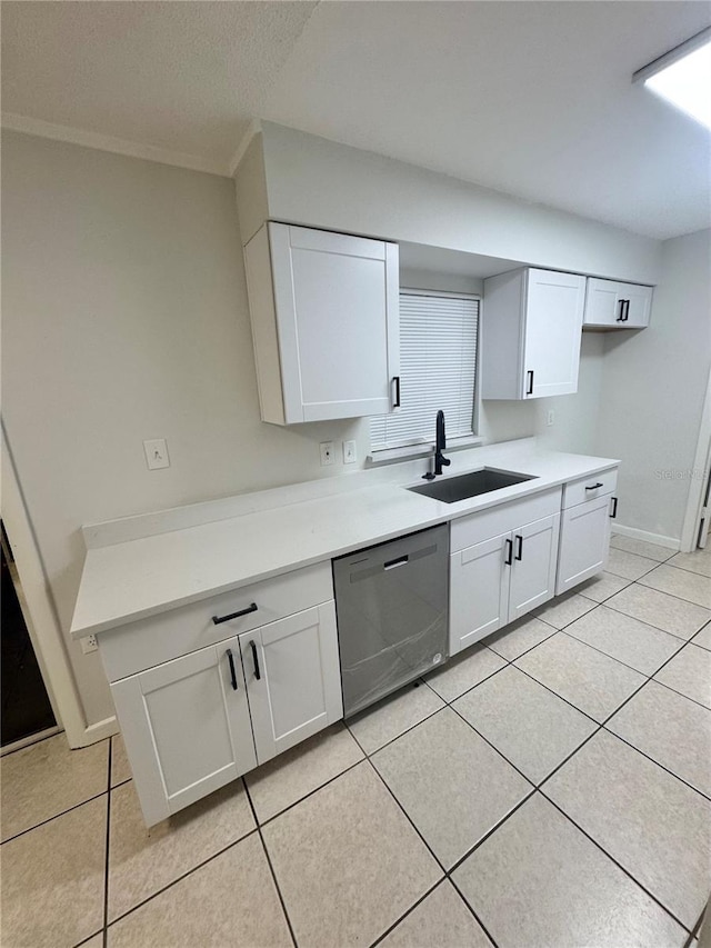 kitchen featuring sink, white cabinets, dishwasher, and light tile patterned flooring