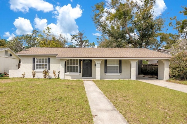 ranch-style home featuring driveway, a front lawn, roof with shingles, and stucco siding