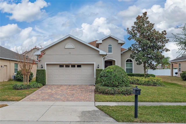 view of front of house featuring a garage and a front lawn