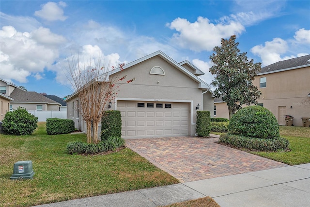 view of front of house featuring a garage and a front lawn