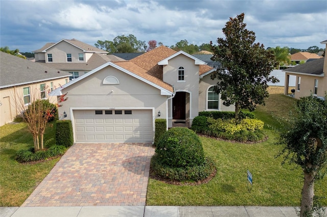 view of front of home with a garage and a front lawn