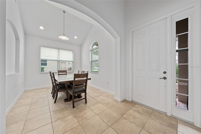 tiled dining room with vaulted ceiling