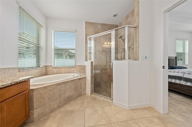 bathroom with vanity, tile patterned flooring, and separate shower and tub