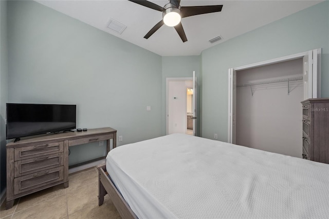 tiled bedroom with ceiling fan and a closet