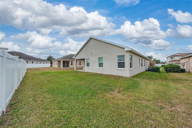 rear view of property with a lawn