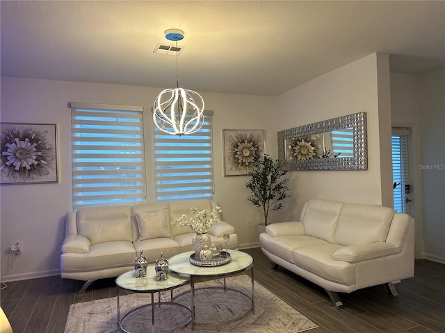 living room with plenty of natural light and a chandelier