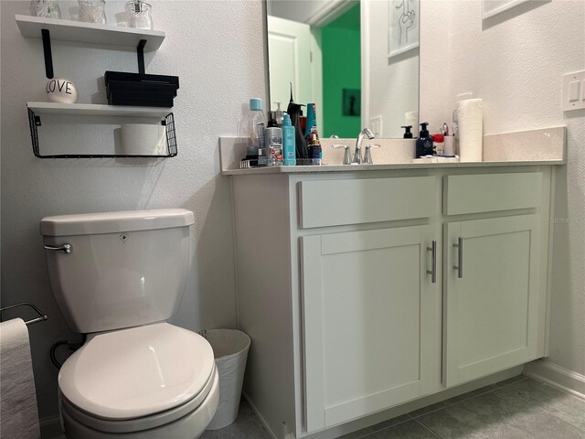 bathroom with vanity, tile patterned floors, and toilet