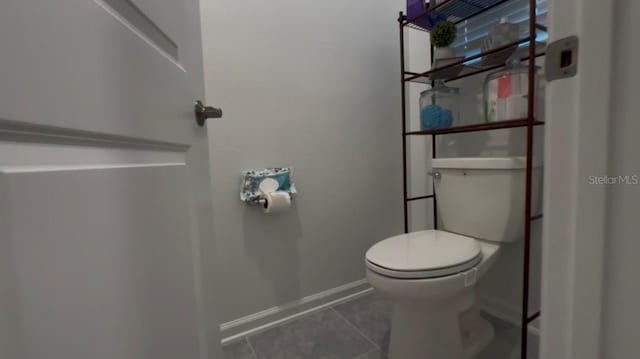 bathroom featuring tile patterned floors and toilet