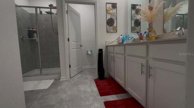 bathroom featuring tile patterned flooring, vanity, and a shower with shower door