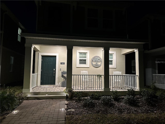 exterior entry at twilight with covered porch