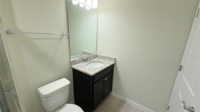 bathroom featuring vanity, toilet, and tile patterned flooring