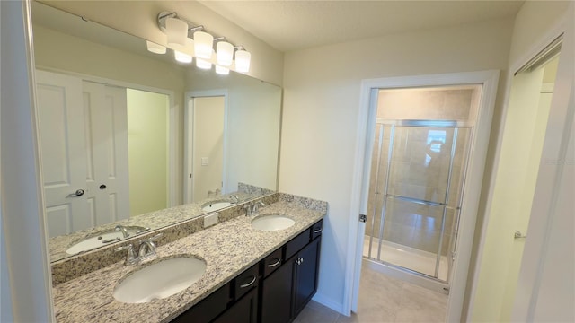 bathroom with a shower with door and vanity