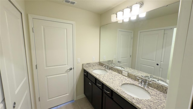 bathroom with vanity and tile patterned floors