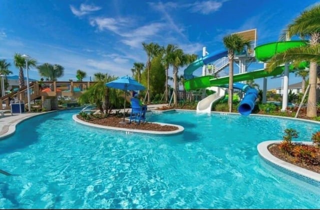 view of swimming pool with a water slide