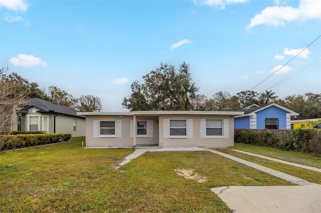 ranch-style home with a front lawn