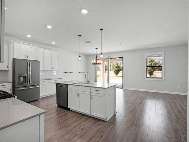 kitchen featuring pendant lighting, sink, white cabinetry, black dishwasher, and stainless steel refrigerator with ice dispenser