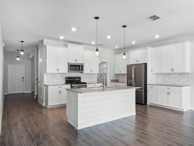 kitchen with sink, stainless steel appliances, hanging light fixtures, and white cabinets