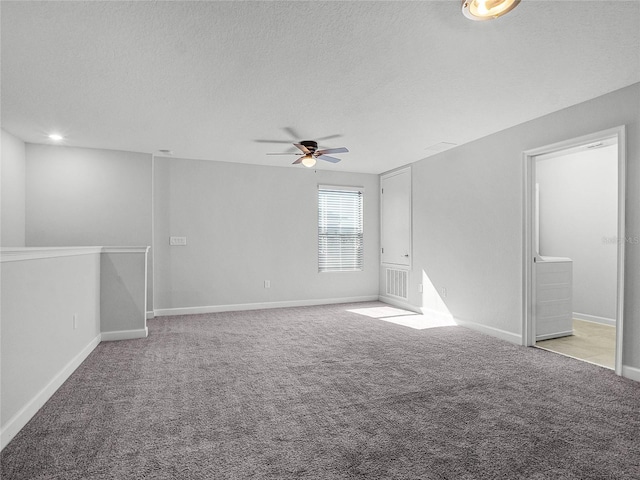 unfurnished room with light colored carpet and a textured ceiling