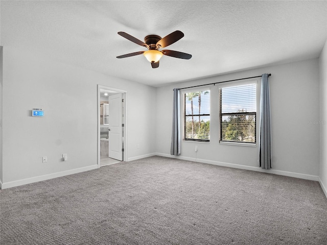 unfurnished room with ceiling fan, light colored carpet, and a textured ceiling