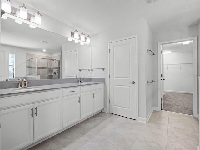 bathroom with a shower with door and vanity