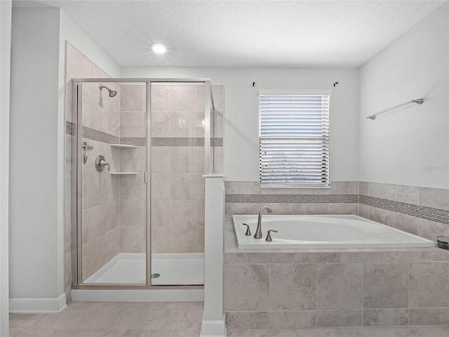 bathroom with independent shower and bath and a textured ceiling