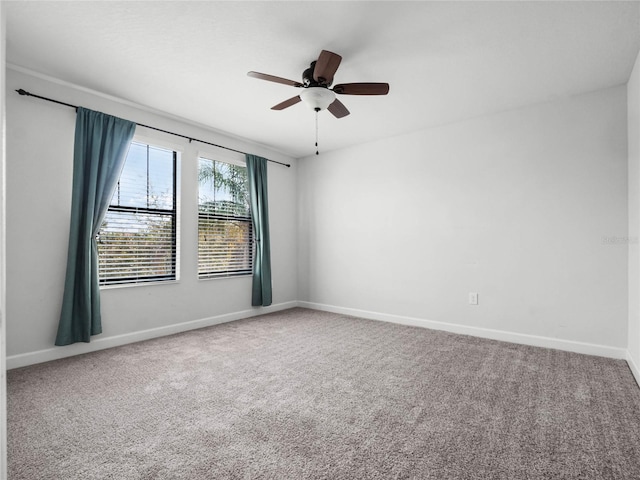 carpeted empty room featuring ceiling fan