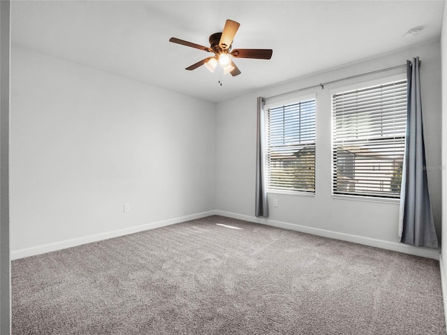 unfurnished room with ceiling fan and carpet flooring