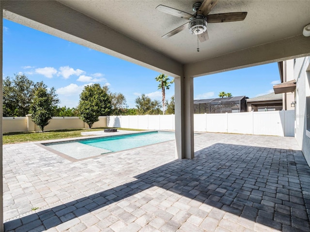 view of swimming pool featuring ceiling fan and a patio area