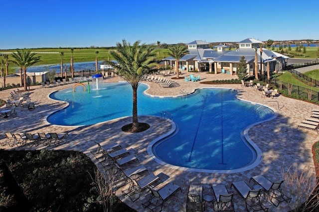 view of swimming pool featuring pool water feature and a patio area