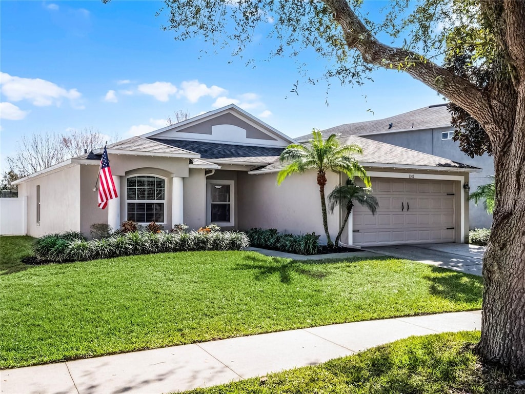 ranch-style home featuring a garage and a front yard