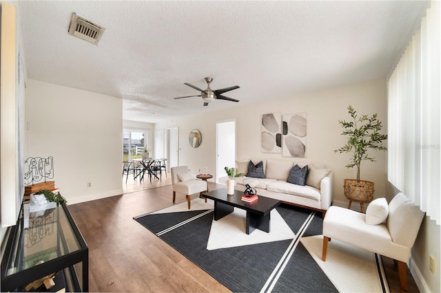 living room featuring dark hardwood / wood-style floors and a textured ceiling