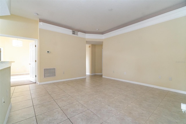 tiled empty room featuring crown molding