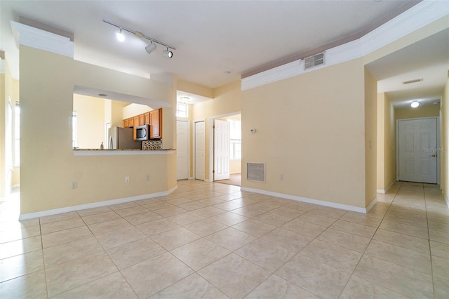 unfurnished living room featuring light tile patterned flooring