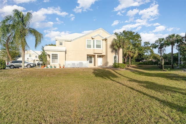 view of front of home with a front yard and stucco siding