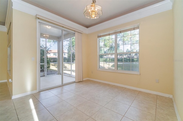 spare room with an inviting chandelier, crown molding, and light tile patterned flooring