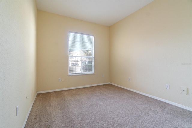 spare room with carpet floors and baseboards