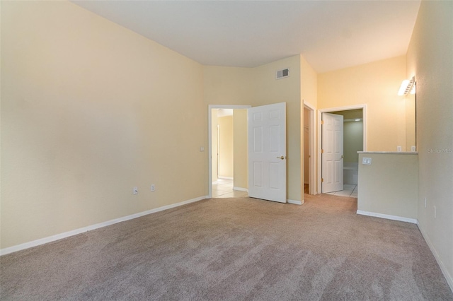 unfurnished bedroom with baseboards, visible vents, and light colored carpet